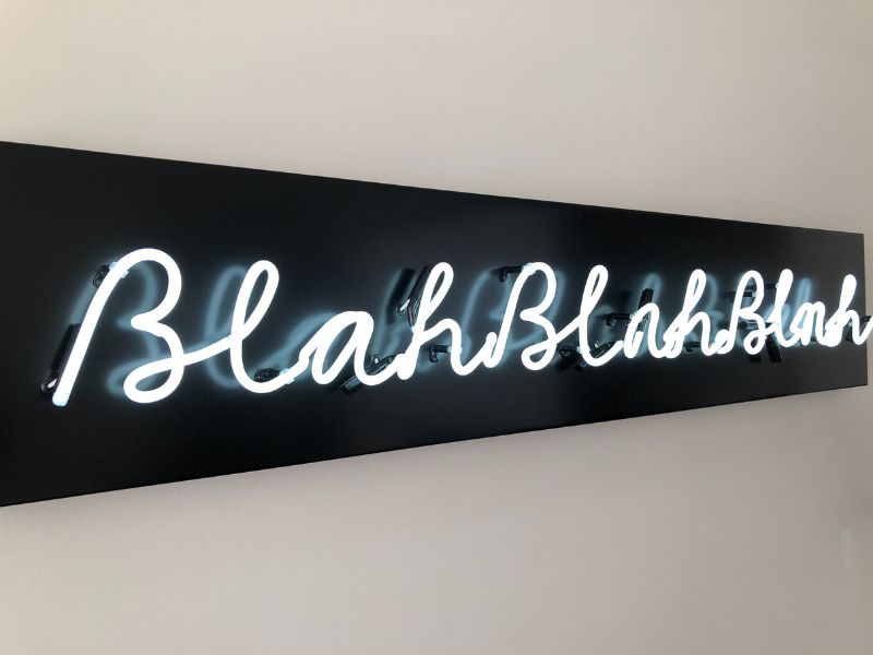a Black banner with the words 'Blah, Blah, Blah' in white handwritten lights